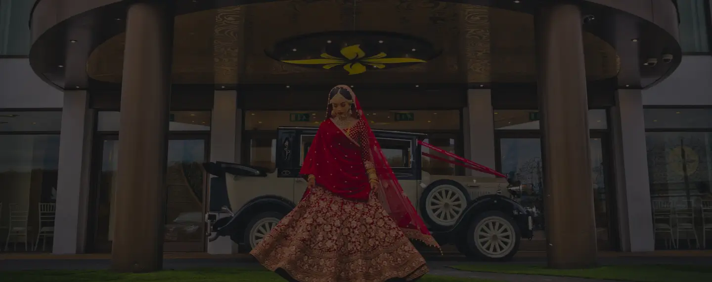 Bride beside a vintage wedding car at the Meridian Grand entrance — wedding venue London.