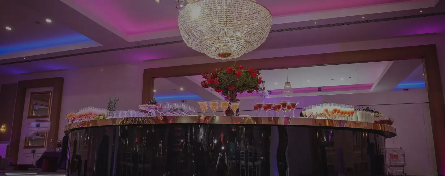 Ballroom set with chandelier and floral centrepieces for a celebration at Meridian Grand — events venue London.