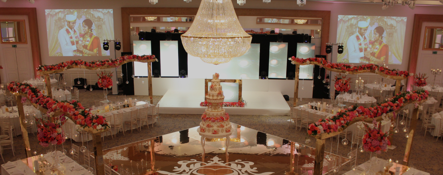 Grand Ballroom set with a stage and aisle at Meridian Grand — Grand Ballroom wedding venue London.