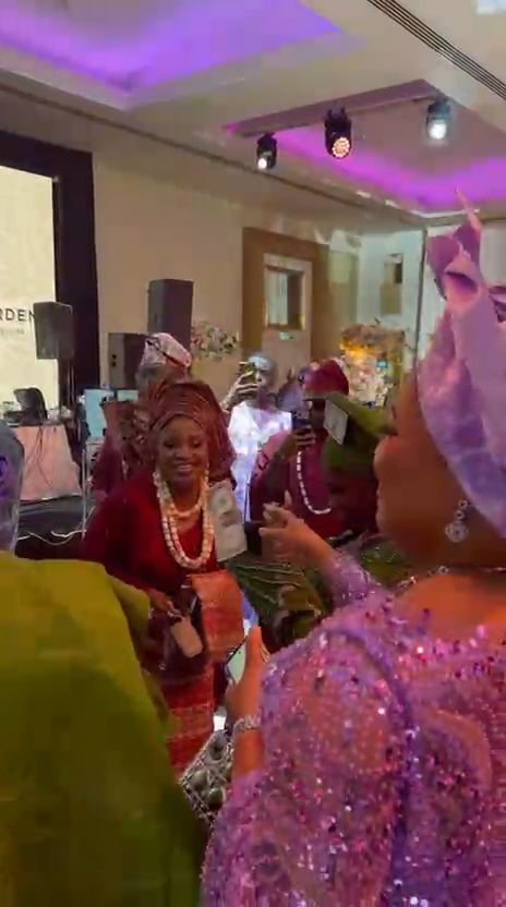 Guests in aso ebi and gele celebrating on the dance floor at a Nigerian wedding at Meridian Grand